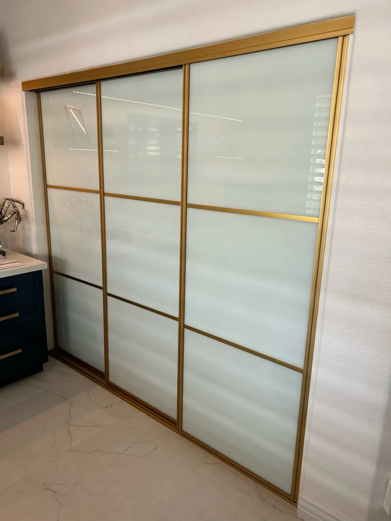 3-lite milky glass in satin gold sliding glass closet door