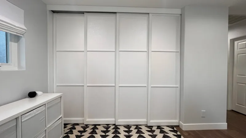 Four-door quad track shoji sliding closet doors with a three-lite lattice