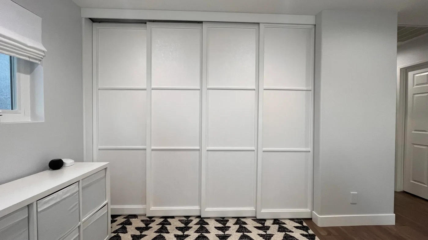 Four-door quad track shoji sliding closet doors with a three-lite lattice