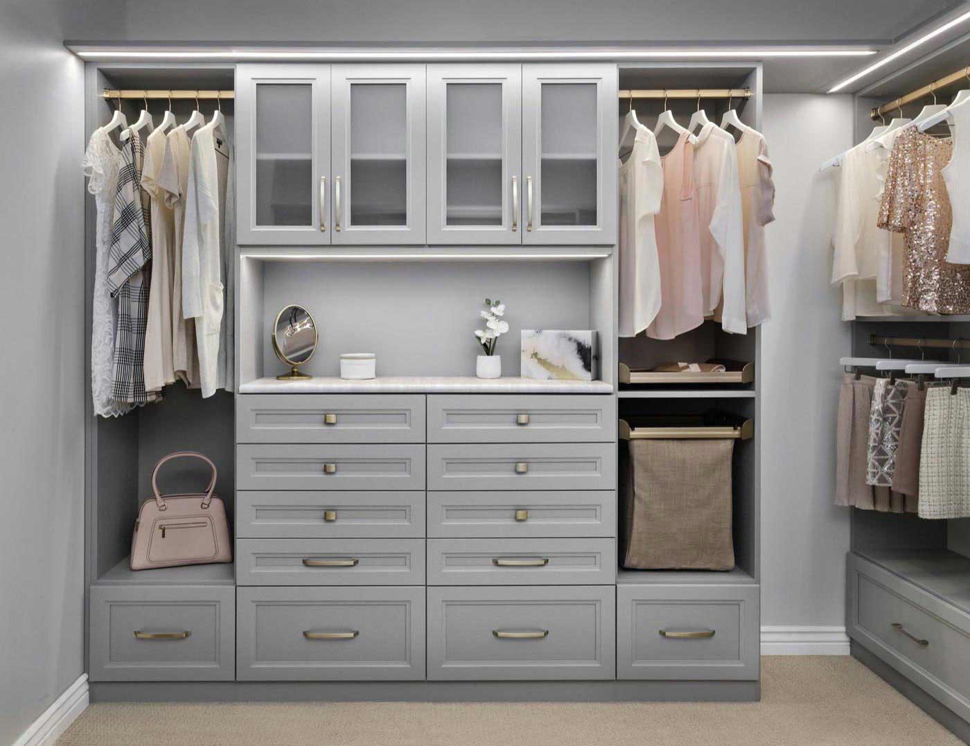 Custom walk-in closet with LED-lit shelving and drawer stacks in Huntington Beach