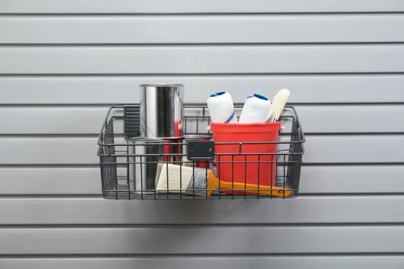 Wire storage basket mounted on a garage slatwall system