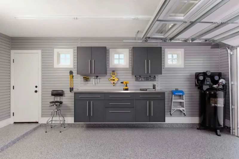 Custom garage storage — granite workbench stainless steel counter