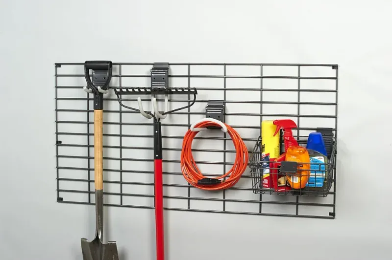 Garage gridwall panel with yard tool hooks and storage basket