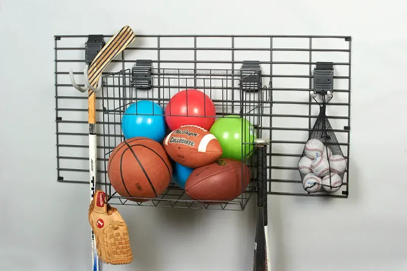 Garage gridwall panel with sports gear storage basket and hooks