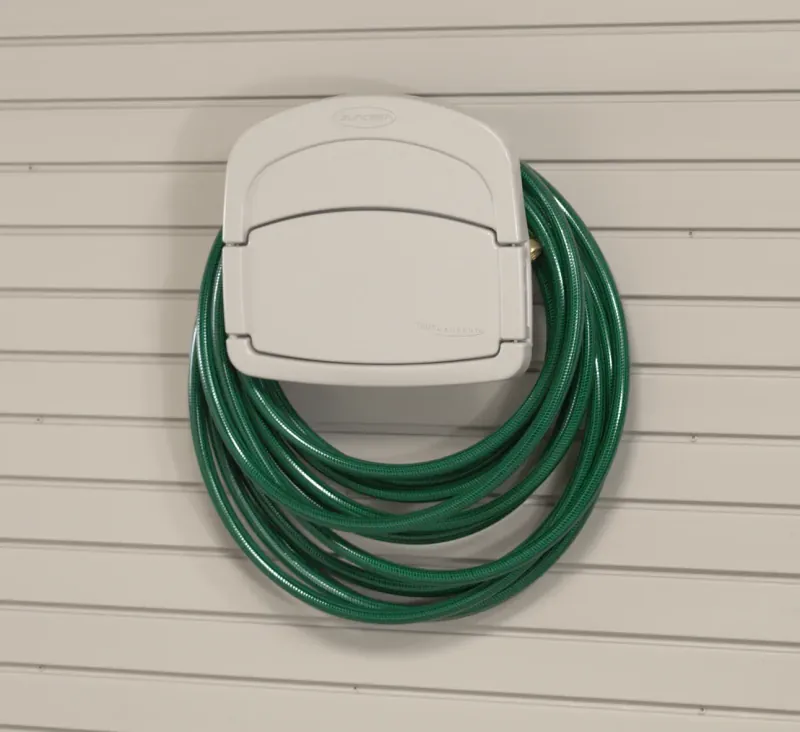 Wall-mounted garden hose holder for a garage slatwall system