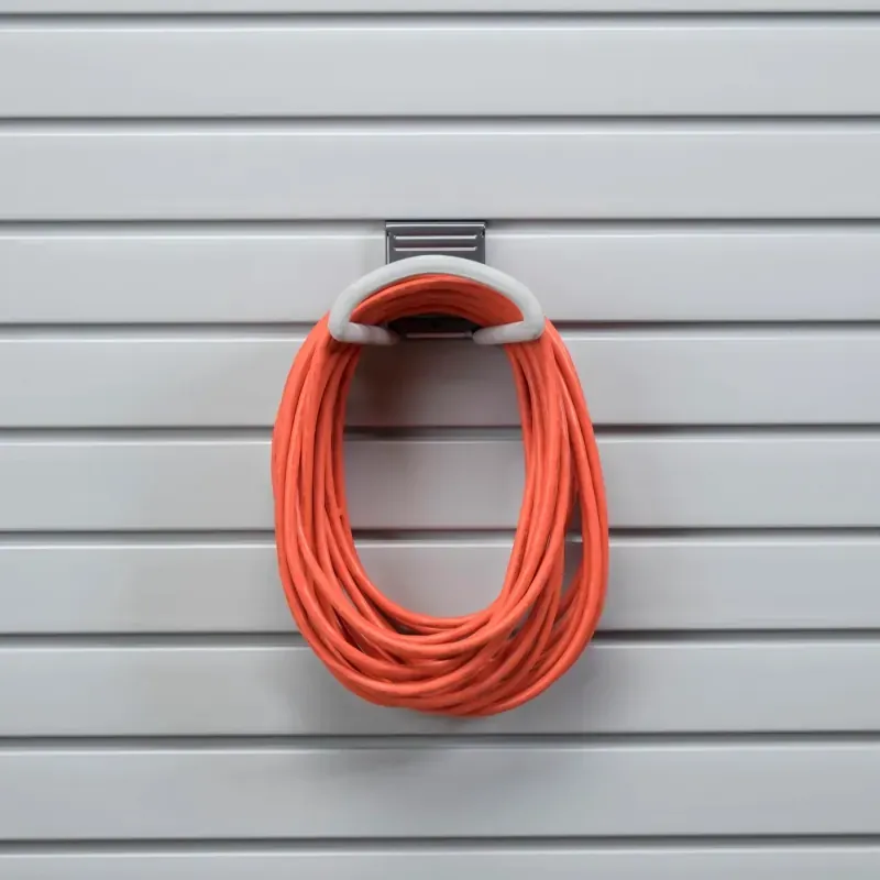 Hose loop hook mounted on a garage slatwall system