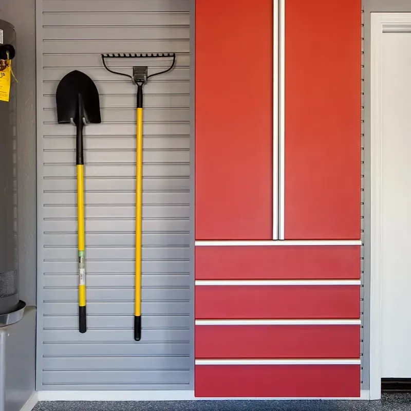 Custom garage storage — red cabinet drawers shovel rake