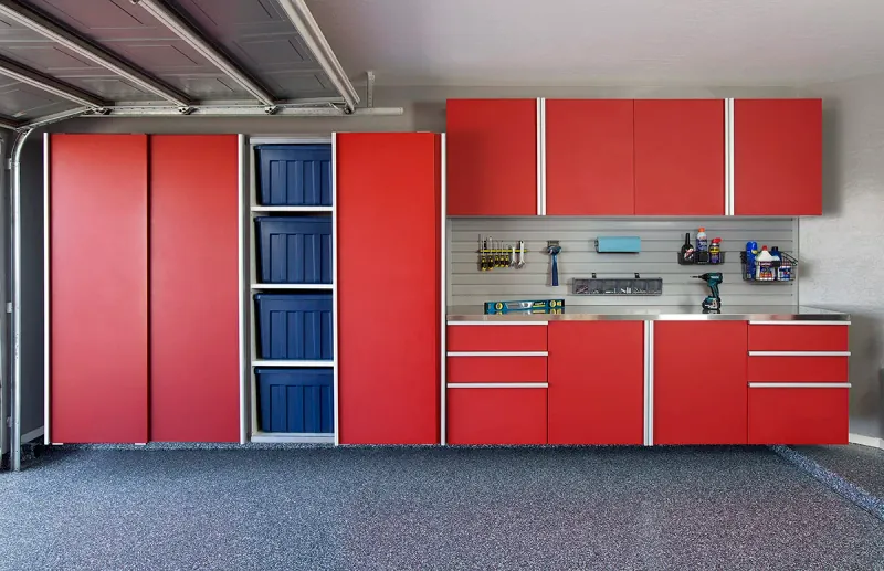 Custom garage storage — red sliding cabinets stainless workbench