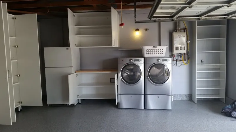 Garage storage cabinets with built-in workbench, refrigerator and laundry area