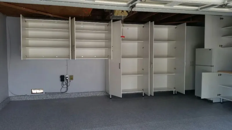 White garage storage cabinets, upper and lower, with open doors