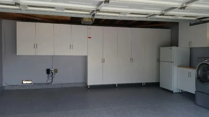 White garage storage cabinets with refrigerator and laundry area