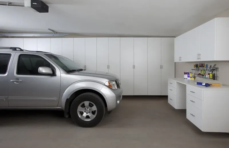 Custom garage storage — white cabinets workbench suv