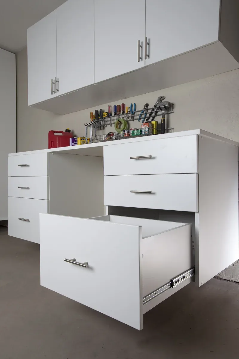 Custom garage storage — white workbench drawers