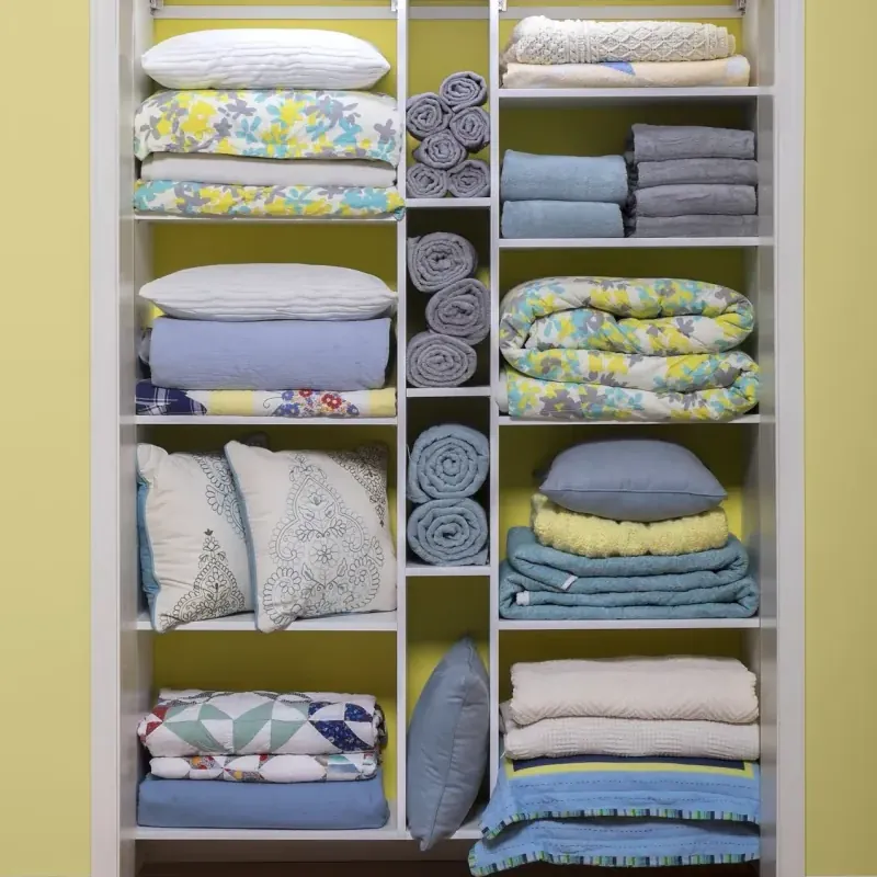White linen closet organizer with shelving for folded towels, sheets and blankets