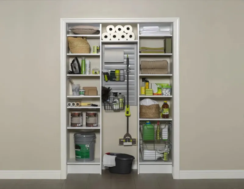 Pantry and utility closet with adjustable shelving, pull-out baskets and cleaning supply storage