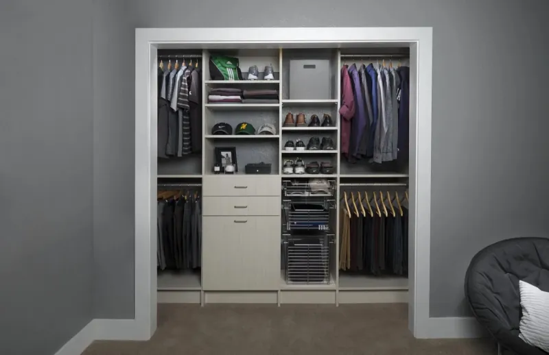 Arctic flat-panel reach-in closet designed for a young man's wardrobe, with shoe shelving and pull-out drawers
