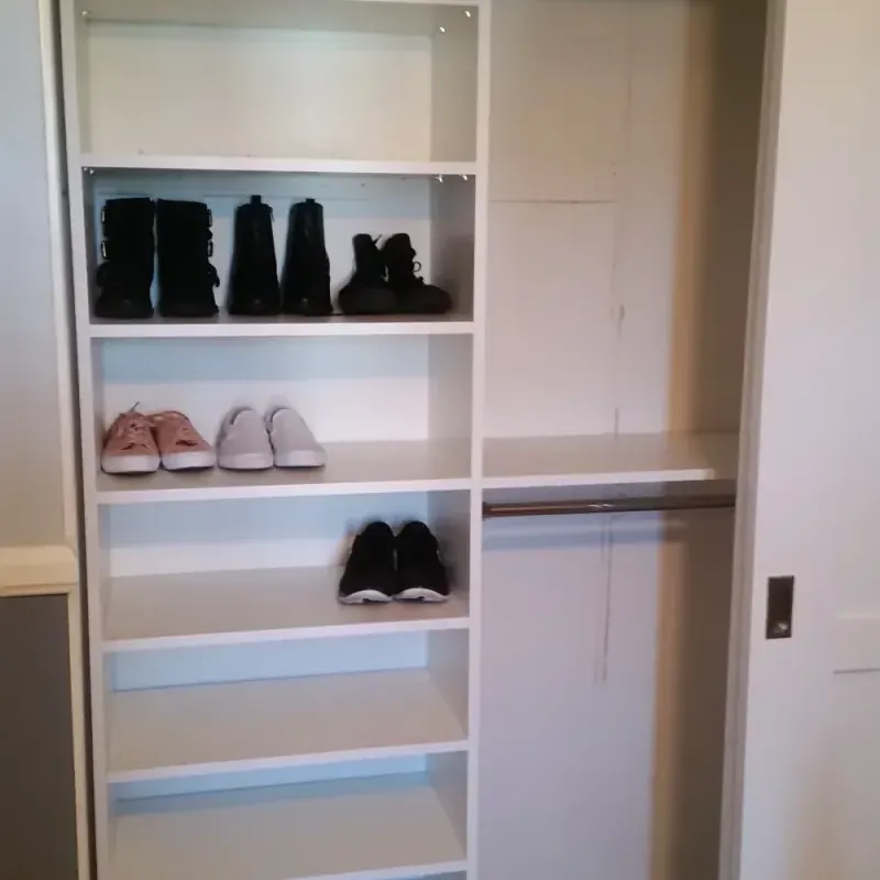 Reach-in closet with sliding door and adjustable shoe shelving