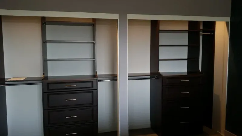 Side-by-side reach-in closets with matching dark wood drawer and shelving units