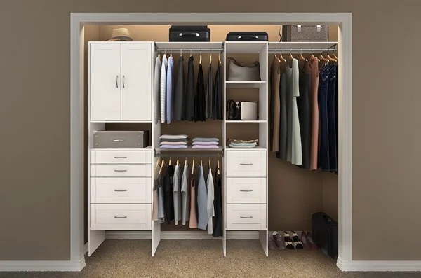 White reach-in closet with built-in cabinet, drawers and hanging storage