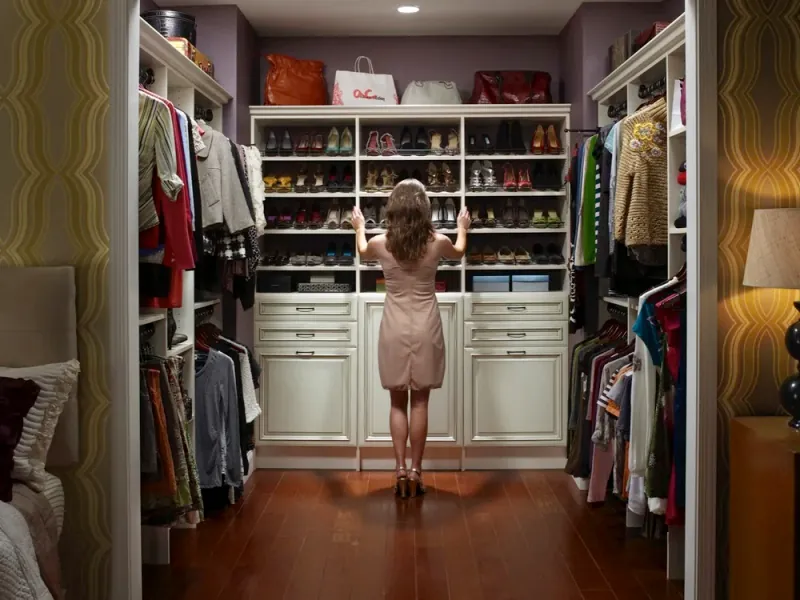 Antique white walk-in closet with mitered corner shelving