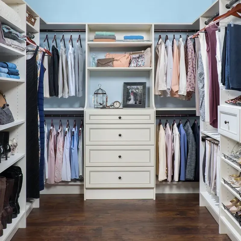 Antique white walk-in closet with hanging storage and open shelving