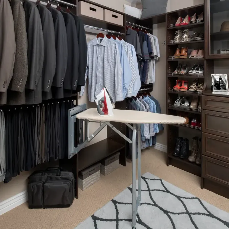 Chocolate pear finish walk-in closet with built-in fold-down ironing board and shoe shelving