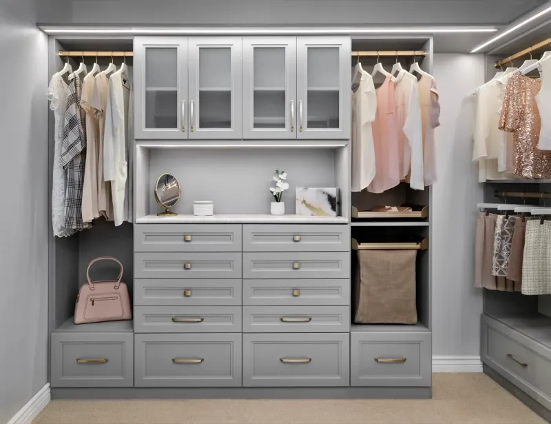 Walk-in closet in cloud finish with integrated shelf lighting