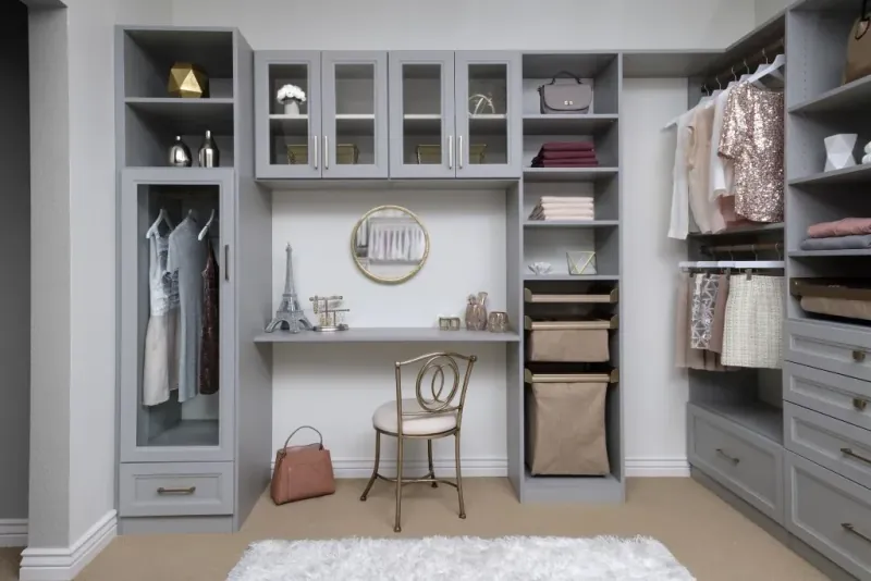 Walk-in closet with built-in vanity desk, mirror and cloud gray cabinetry