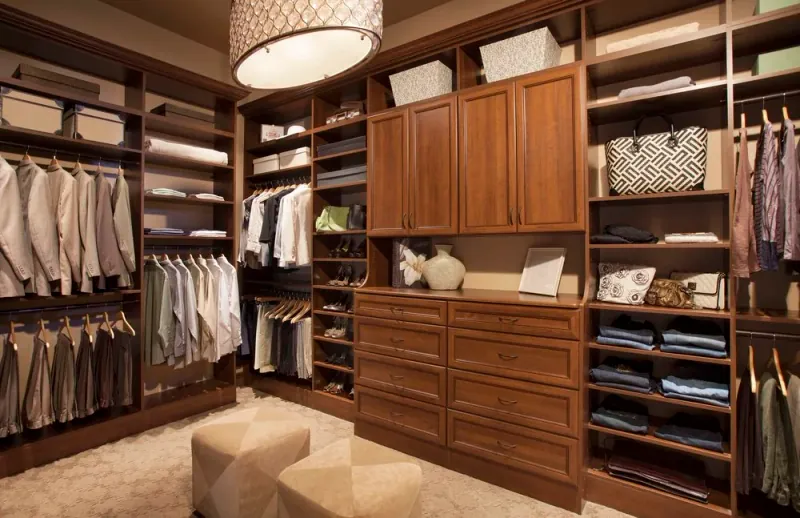 Coco-finish walk-in closet with hanging storage, shoe shelving and cabinetry