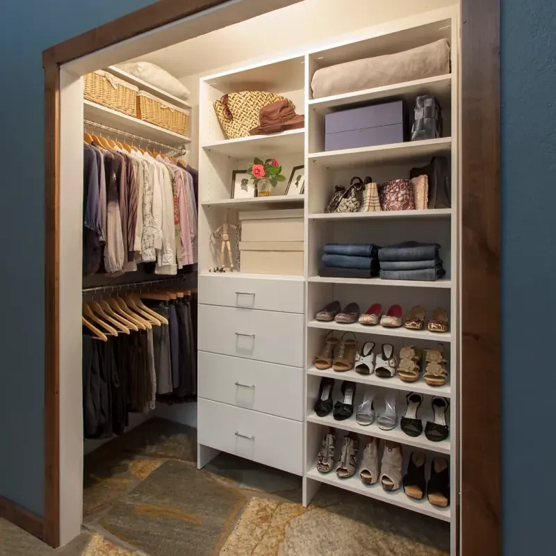 Modern white walk-in closet with open shelving and hanging storage