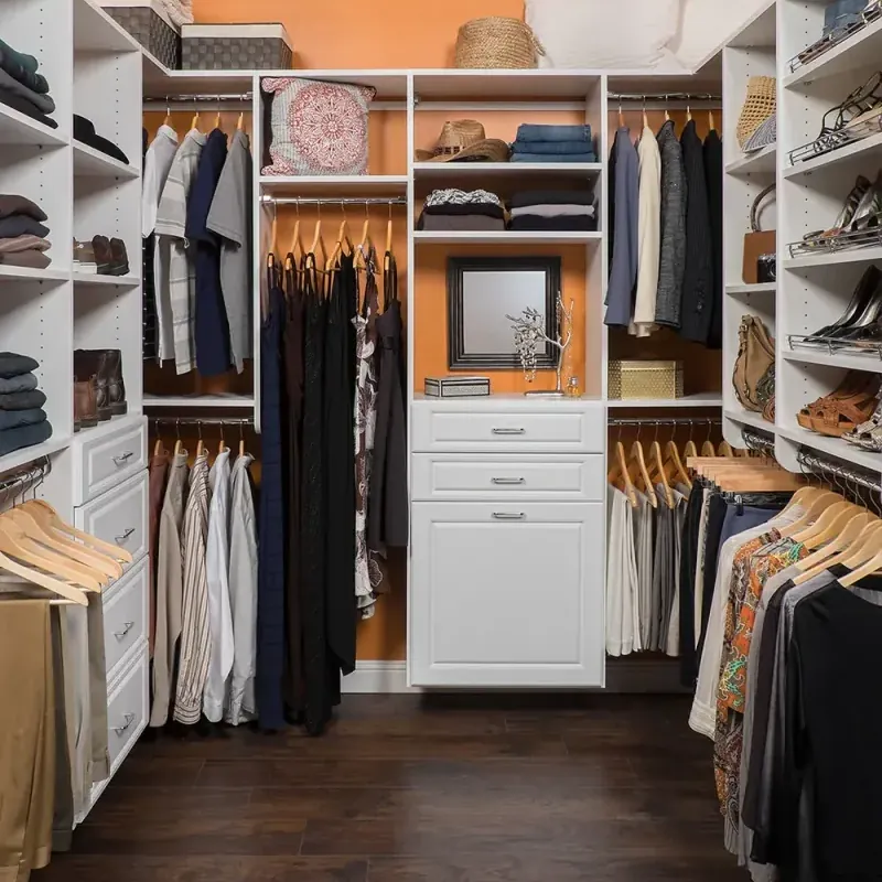 White raised-panel walk-in closet in a compact layout