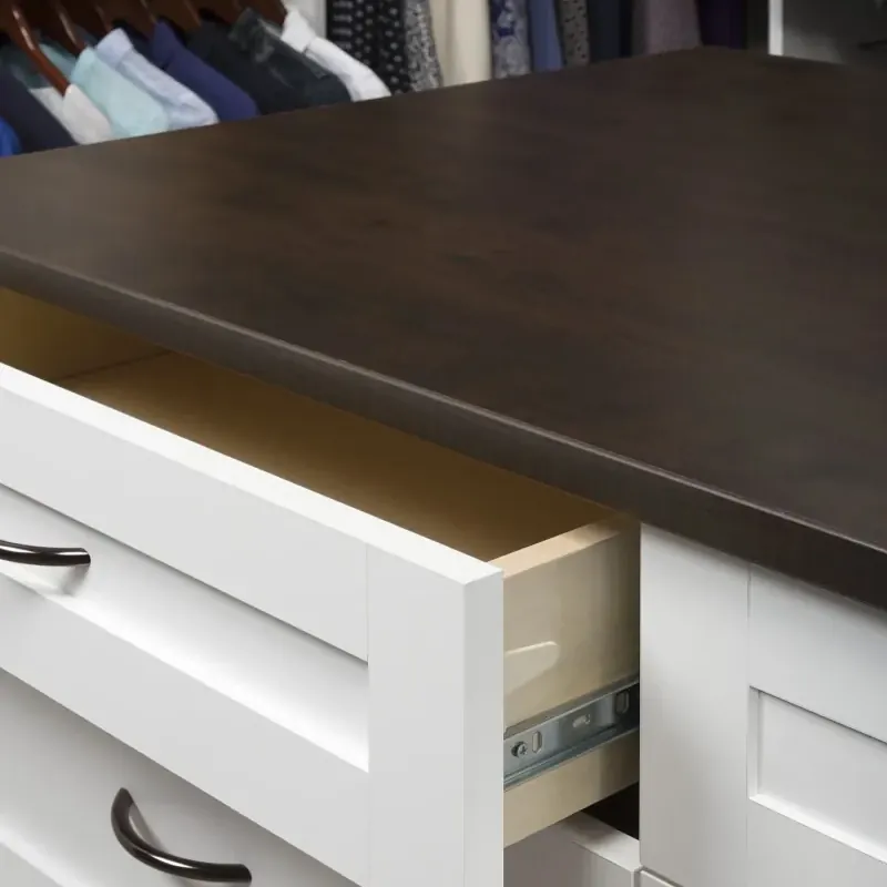 Detail of a soft-close drawer in a white shaker walk-in closet island