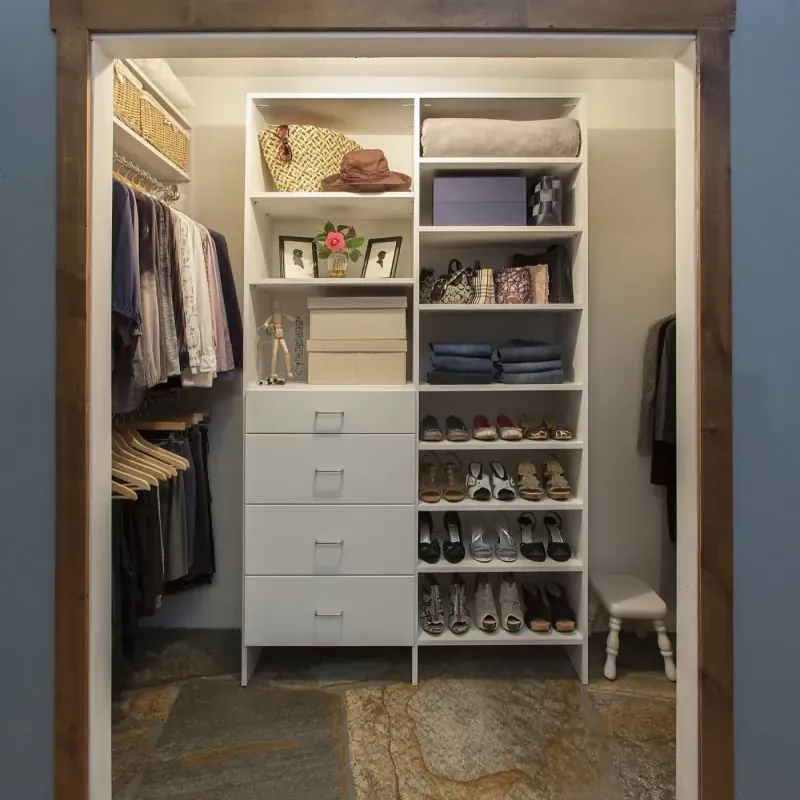 Classic white custom walk-in closet with shoe shelves and drawer stack, Orange County